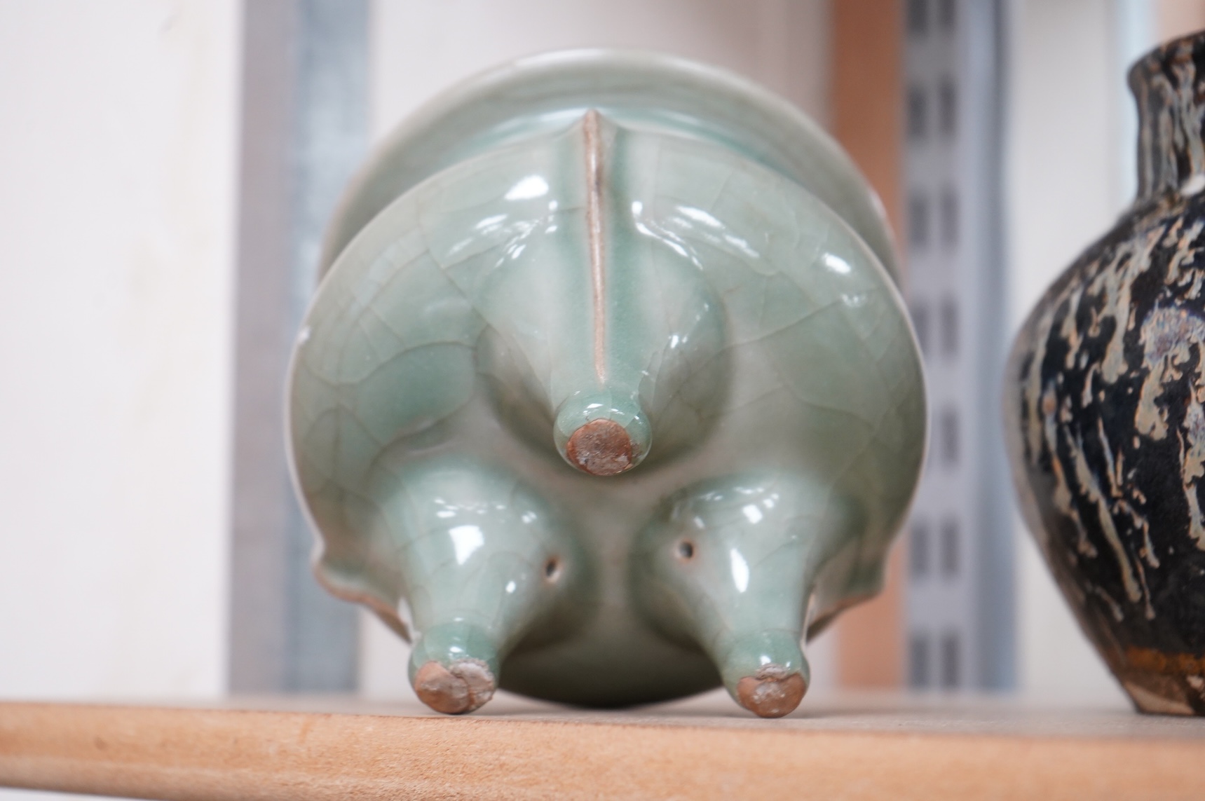 A Chinese celadon tripod censer and vase, largest 14cm high